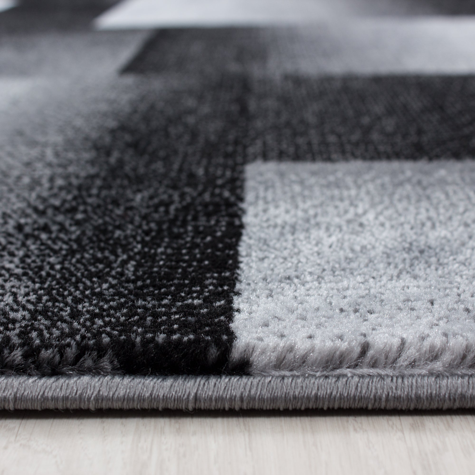 Modern short pile carpet for living room, abstract checkered design, black, easy to care for